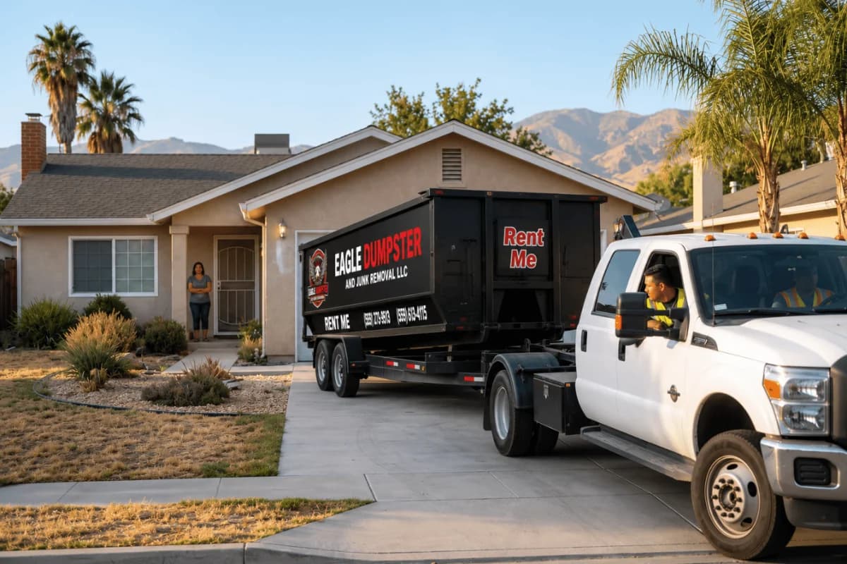 Eagle Dumpster truck delivering a roll-off dumpster at sunset in the Central Valley